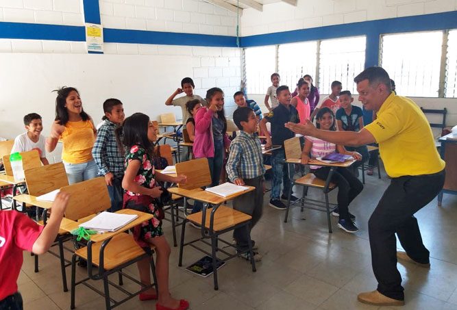 Photo of elementary school teacher with students.