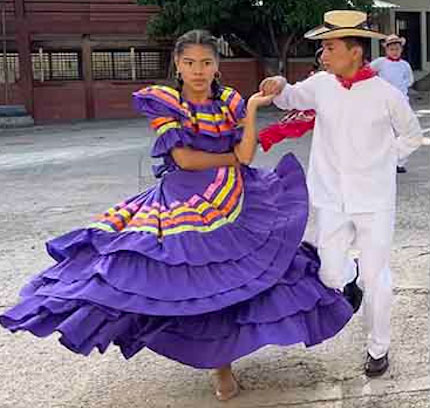 Photo of two students performing traditional dance.
