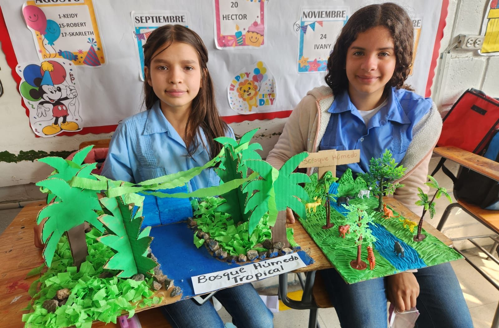 Photo of two girls with tropical trees project